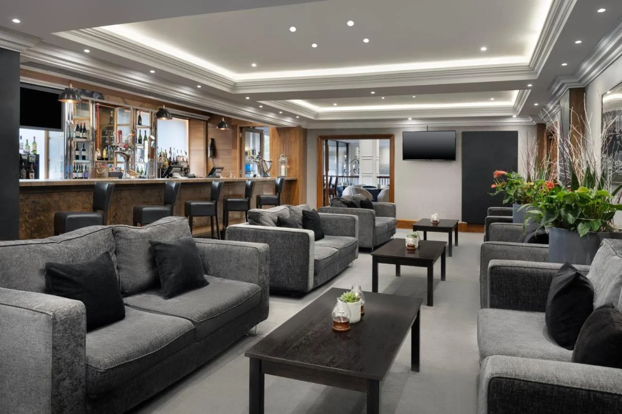 a living room with couches and a bar at Delta Hotels by Marriott Bristol City Centre in Bristol