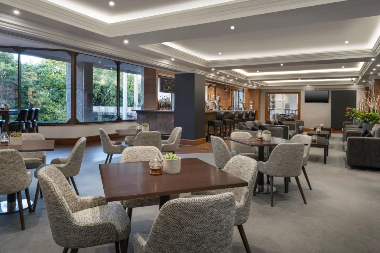 a restaurant with tables and chairs and a bar at Delta Hotels by Marriott Bristol City Centre in Bristol