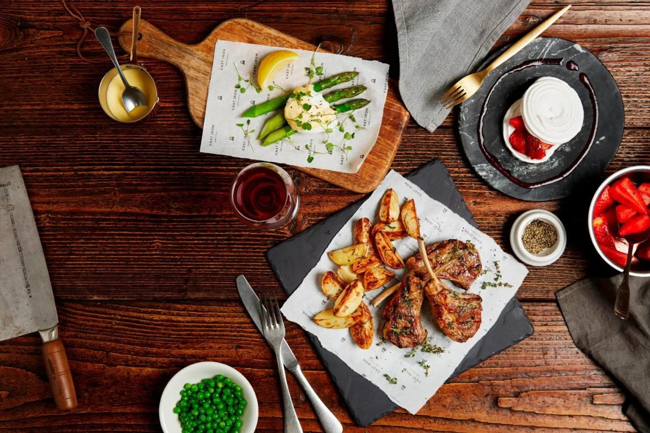 a wooden table with plates of food on it at Delta Hotels by Marriott Bristol City Centre in Bristol